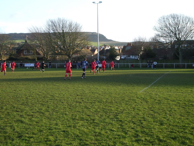 Seaford Town playing at the Crouch, with Seaford Head rising behind the pitch