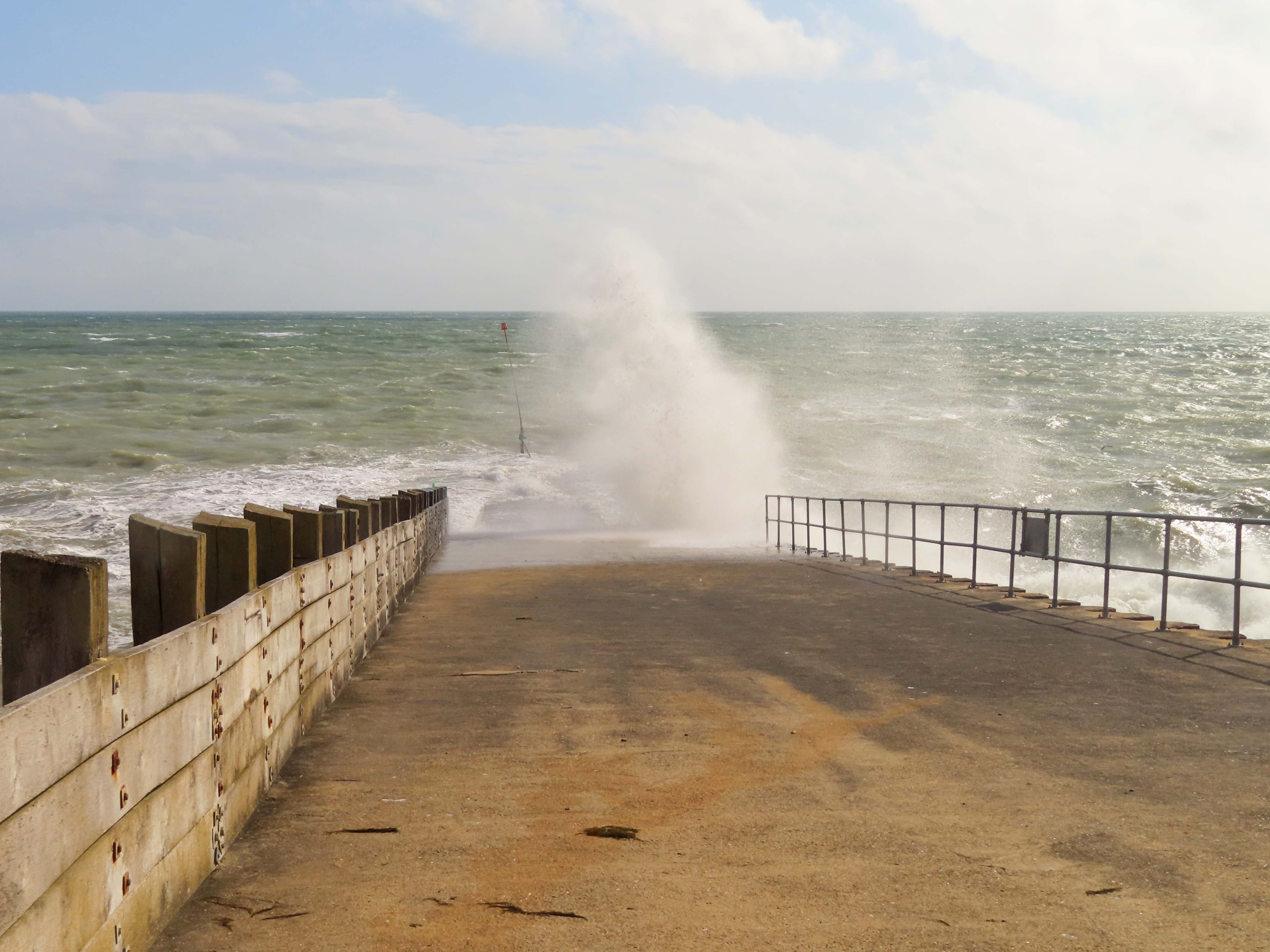 A modern slipway leading from the seafront down onto the shingle at Seaford