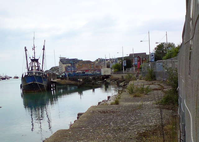 Quayside on the River Ouse at Newhaven, with a fishing boat moored alongside