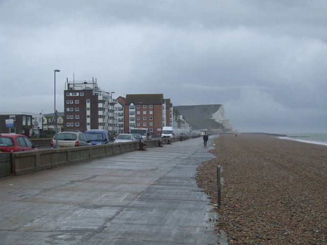 The shingle beach and seafront at Seaford looking eastwards toward the Martello Tower