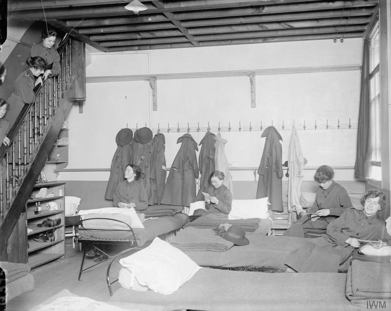 Members of the Women's Army Auxiliary Corps in their dormitory at Rouen in July 1917, with rows of iron beds